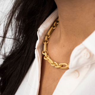 gold chain on a woman with white shirt